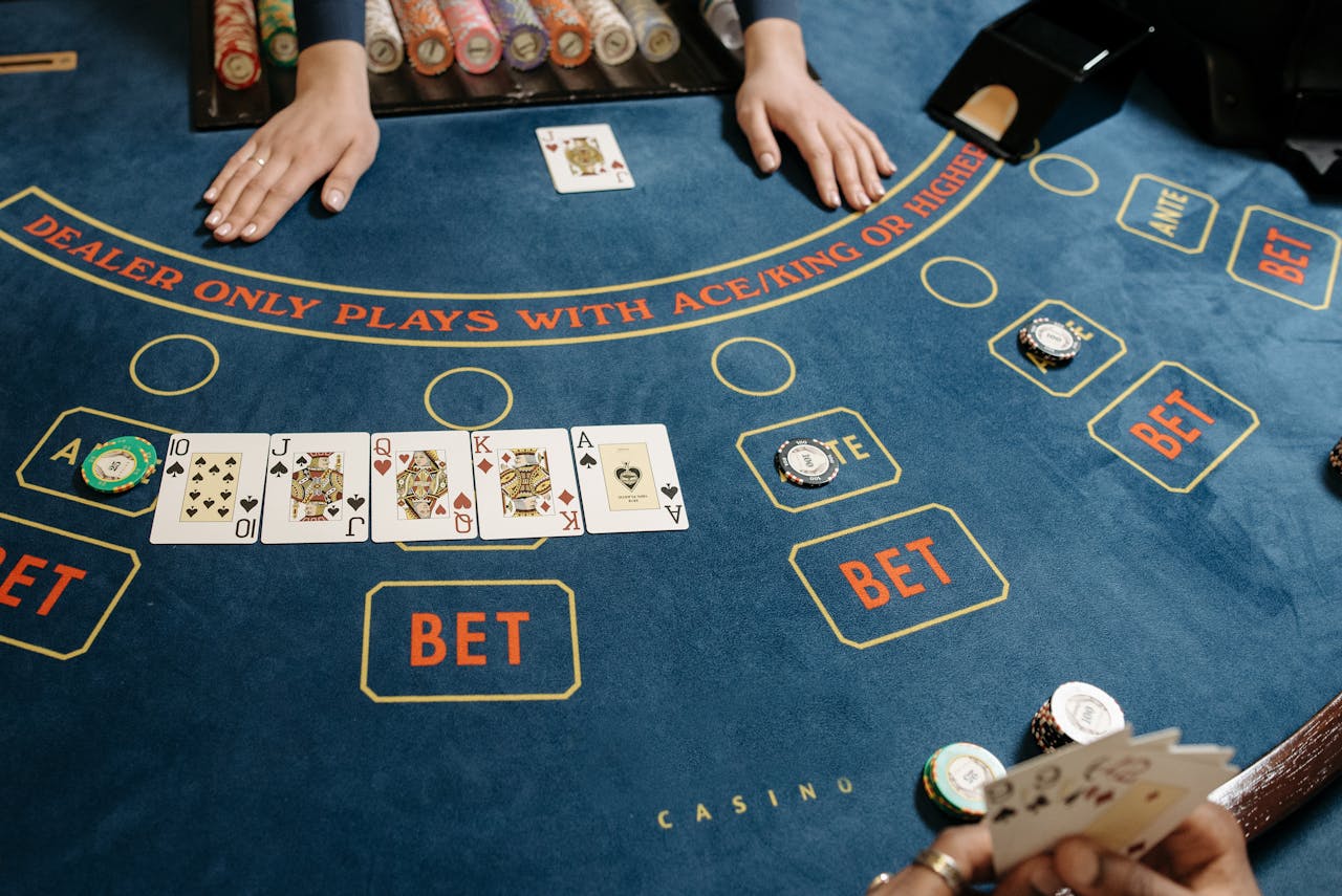 services-01 A casino gaming table featuring poker cards and chips, showcasing a vibrant gambling scene.